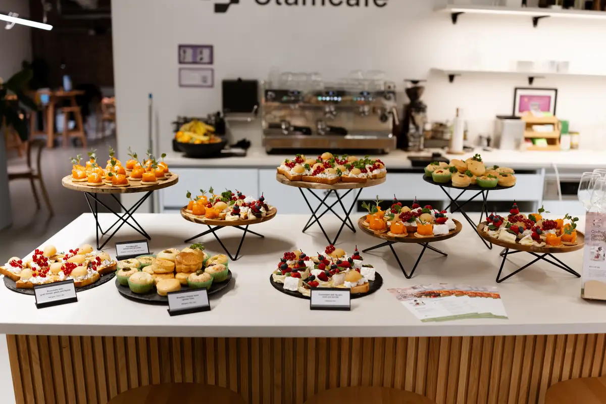 Assorted catering canapés displayed on wooden serving stands
